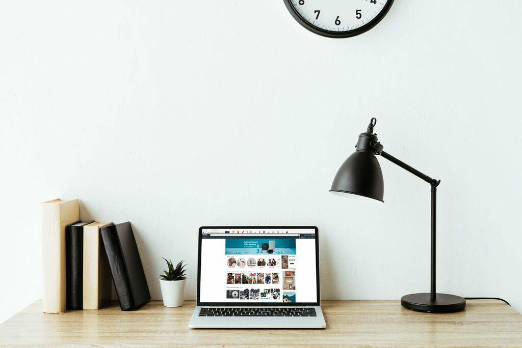 laptop with amazon website on screen on work desk L8QGY34 min 2 scaled