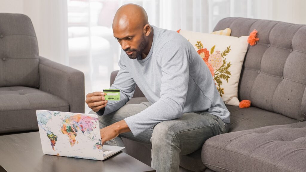 A man using a card to shop online